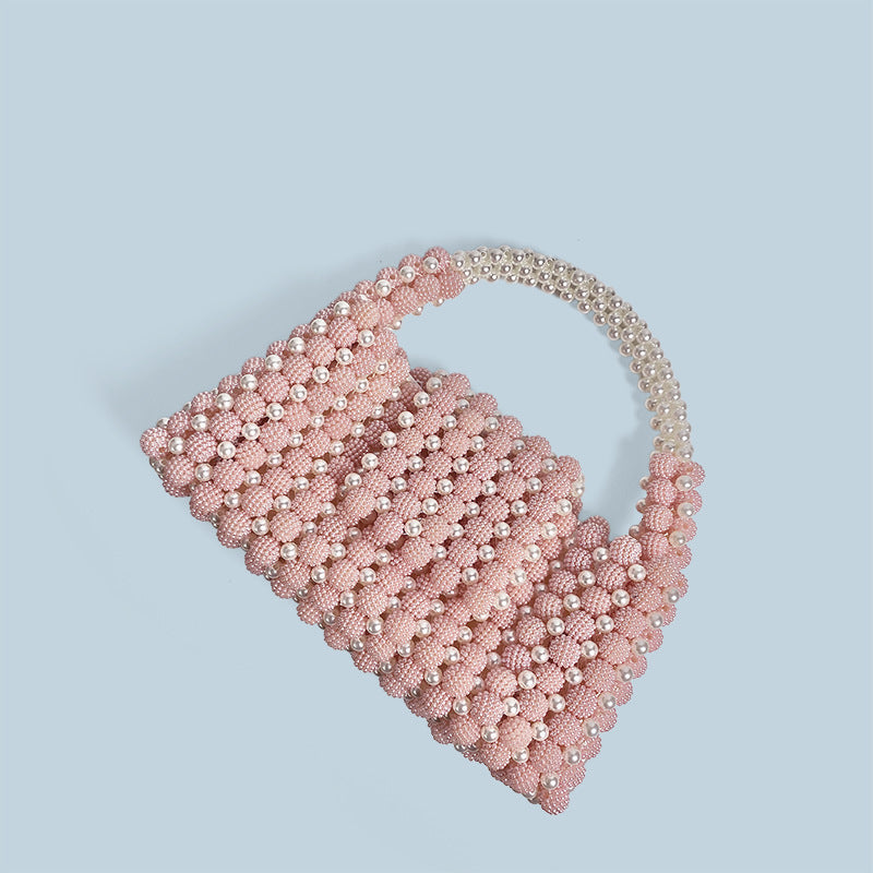 Pink pearl-beaded ball handbag, angled view showing scalloped beaded edge