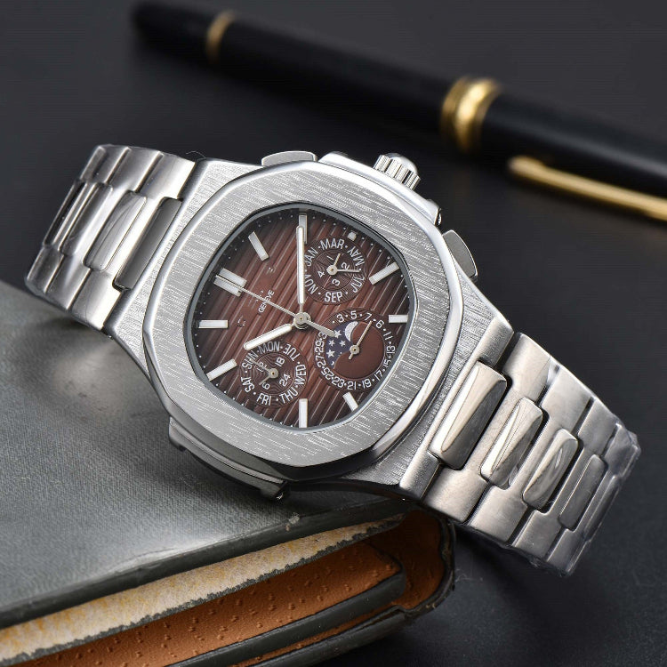 Silver wristwatch with a detailed face on a dark surface