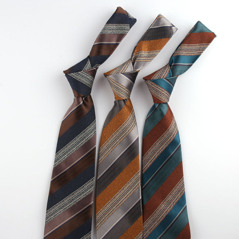 Three striped ties in brown, blue, and orange on a white background