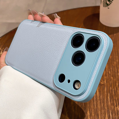 Light blue phone case with multiple camera lenses held by a person on a wooden surface.