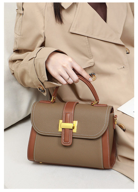 Women’s leather handbag on arm, camel flap bag with contrast brown strap and gold buckle detail