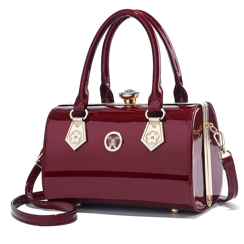 Red handbag with gold accents on a white background