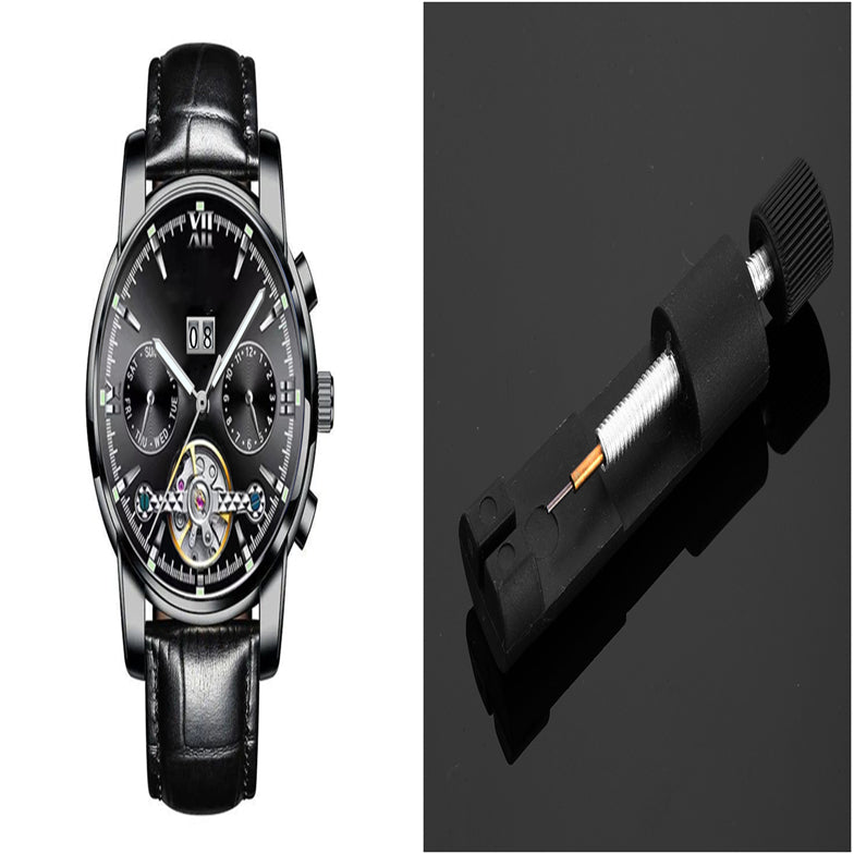 Black wristwatch with detailed face and black leather strap on a dark background