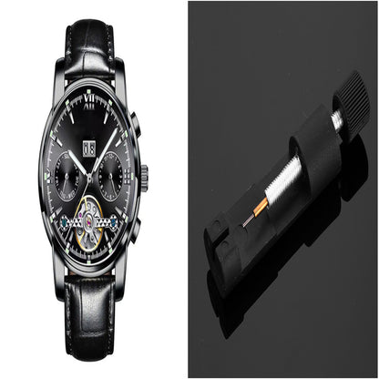 Black wristwatch with detailed face and black leather strap on a dark background