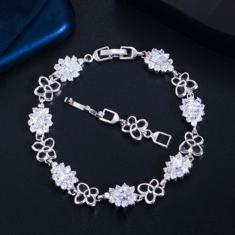 18K gold-plated zircon bracelet with white/clear gemstone links, heart motif chain