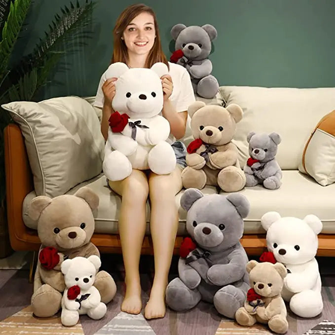 Woman holding a large white teddy bear with smaller teddy bears. YAXSO UAE ONLINE STORE
