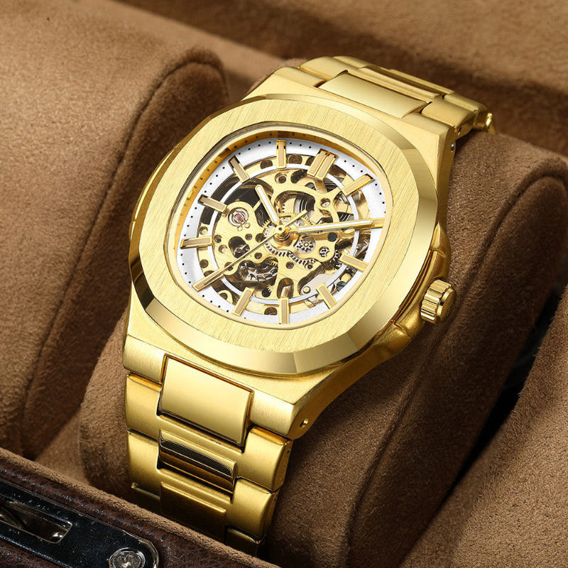 Gold skeleton mechanical watch on brown cushion, open dial with exposed gears