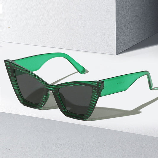 Green cat-eye sunglasses with dark tinted lenses and slim angular frame