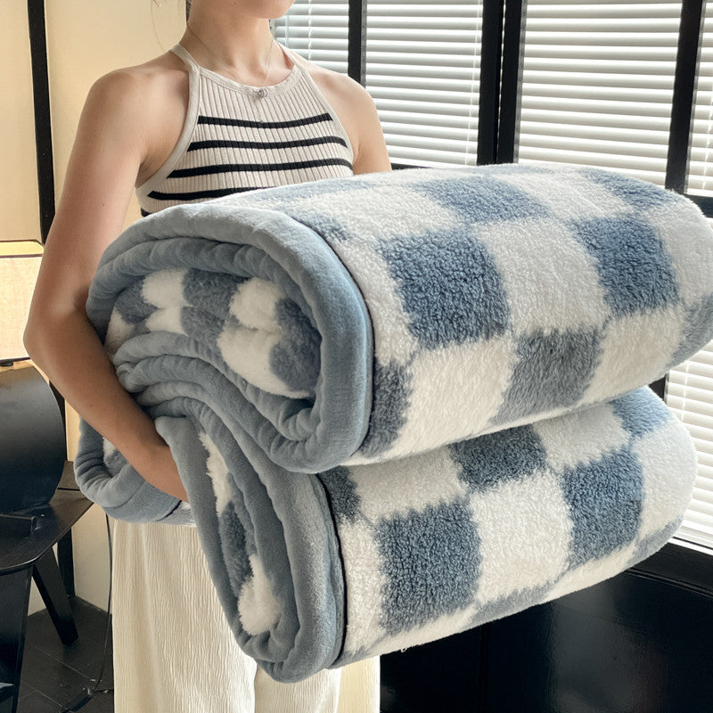 Blue and white check plaid fleece blanket rolled with soft gray trim