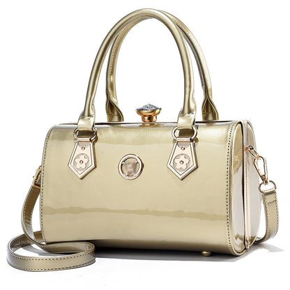 Gold handbag with decorative elements on a white background