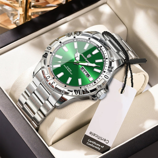 Silver watch with green face in a box, featuring a certificate of conformity tag.