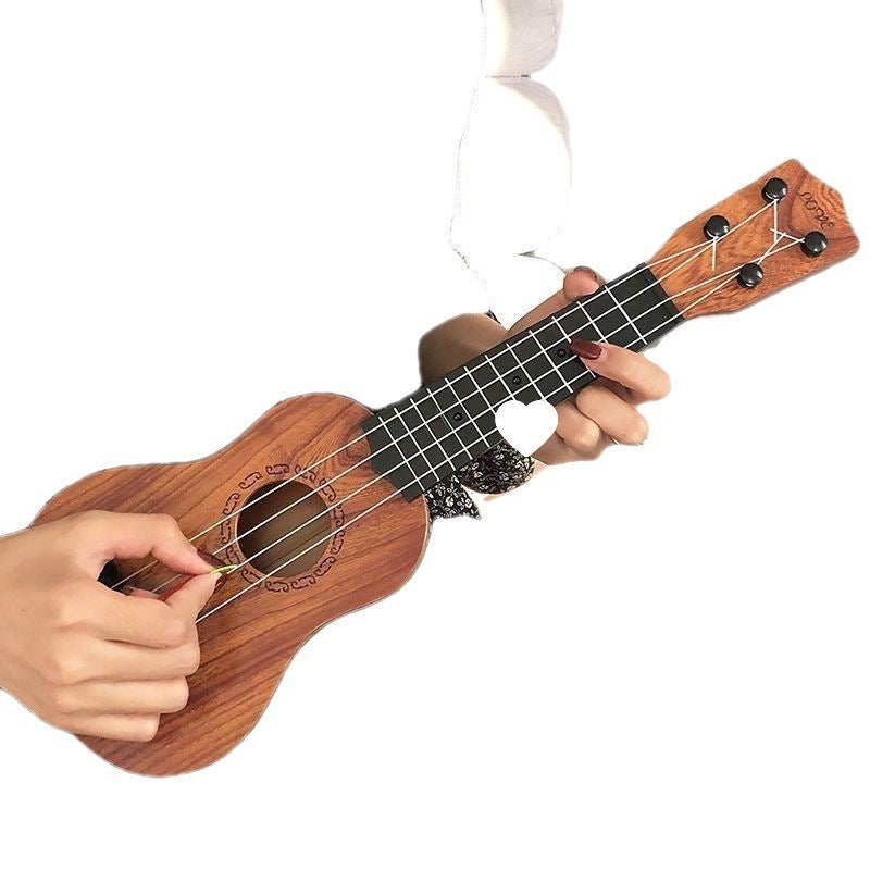 Kids wooden 4-string ukulele toy being played; front view of body, strings, and tuning pegs