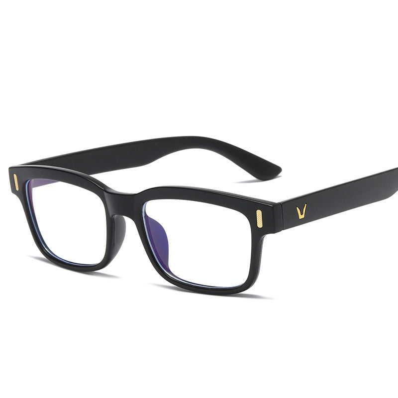 Black eyeglasses with gold accents on a white background