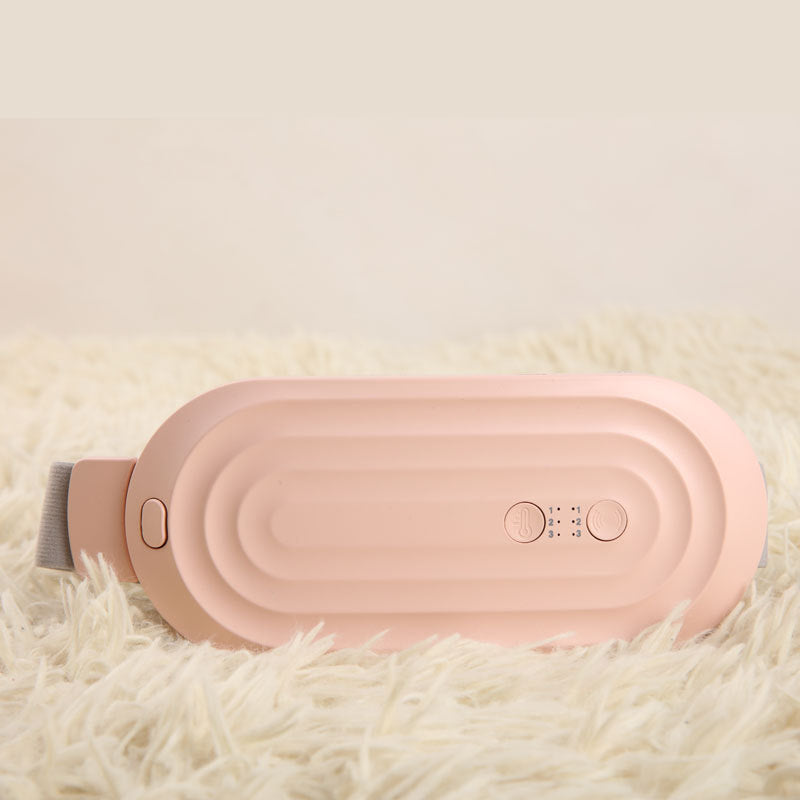 Pink electric waist massager belt, showing textured back panel and control buttons.