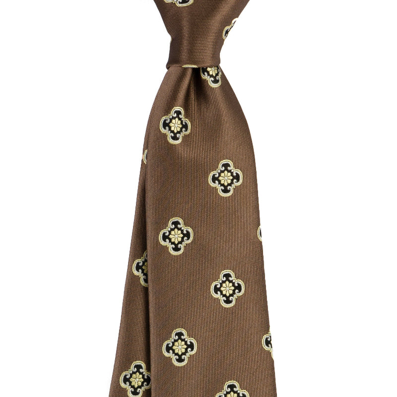 Brown necktie with gold quatrefoil-style emblem repeat