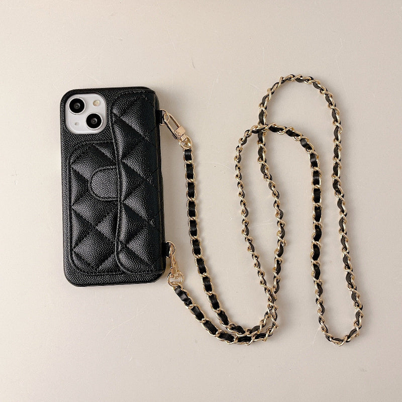 Black quilted phone case with a chain strap on a beige background