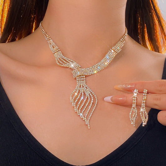 Woman wearing a sparkling necklace and earrings on a plain background