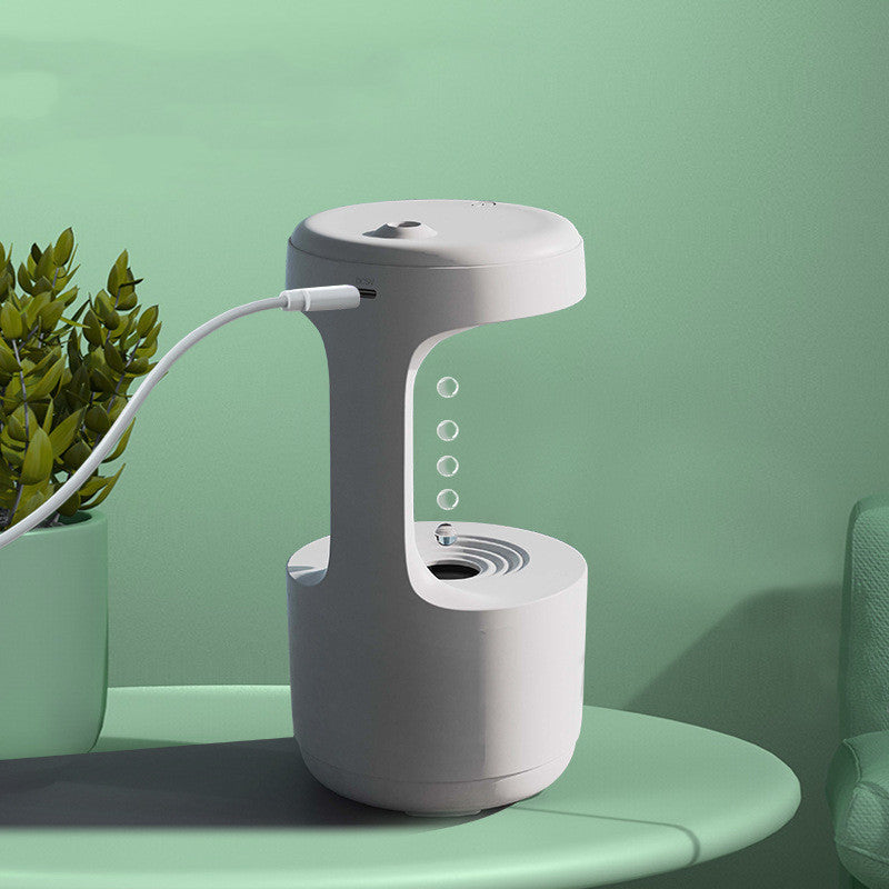 Grey-and-white anti-gravity humidifier on table with mist nozzle and side panel