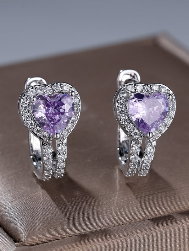 Heart-shaped silver ear clips with purple gemstone centers and pavé accents