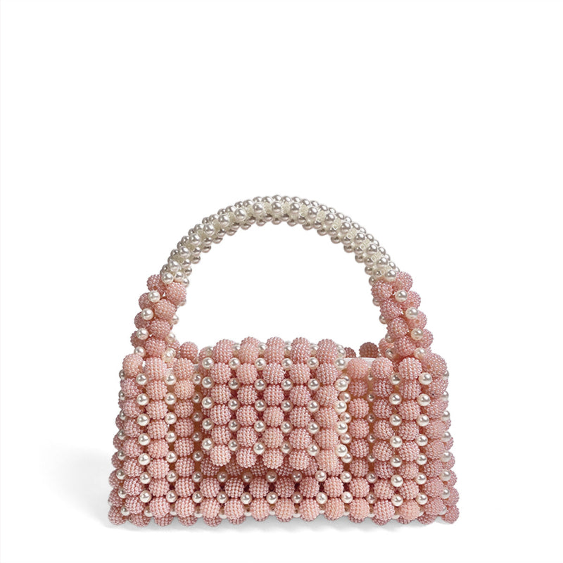 Pink pearl-beaded ball handbag with rounded beaded handle and textured bead front