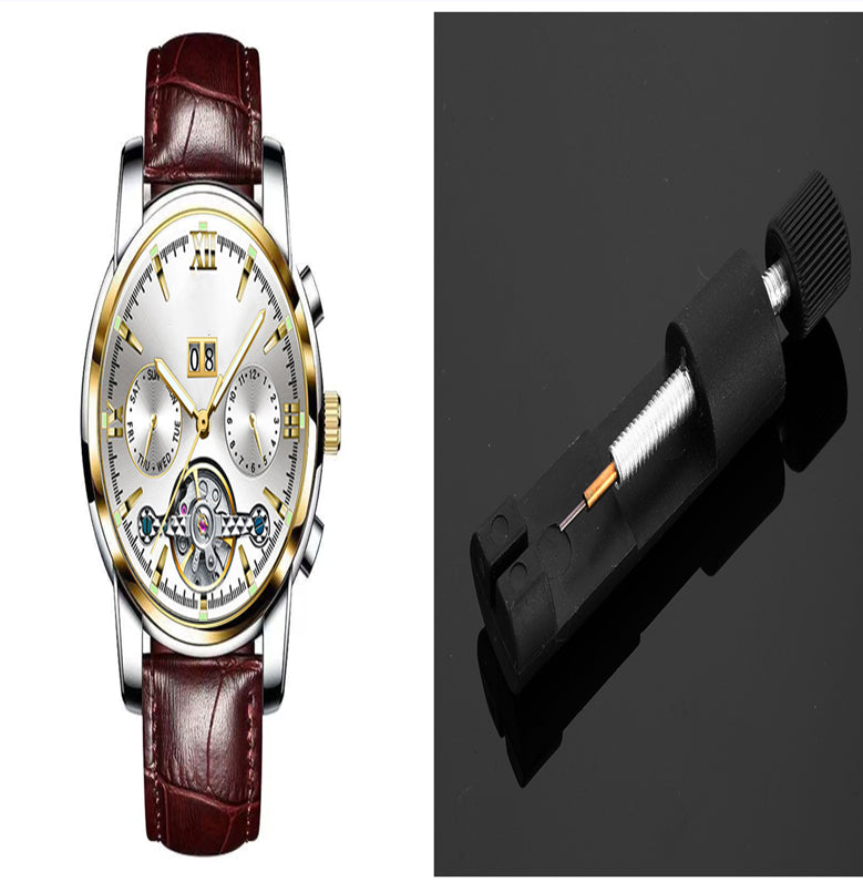 Luxury watch with brown leather strap and detailed face, alongside a black pen on a dark background.