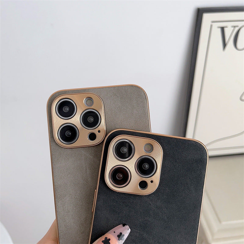 Two phone cases with camera lens design on a light gray background