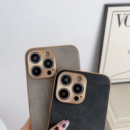 Two phone cases with camera lens design on a light gray background