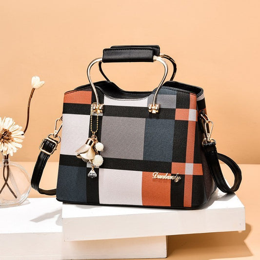 Plaid patterned handbag with decorative elements on a beige background