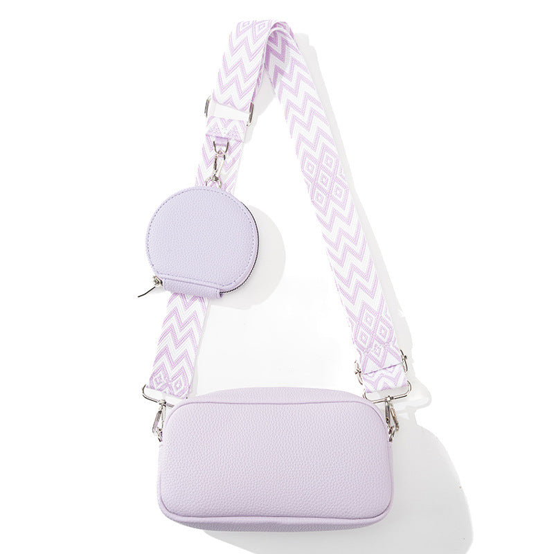 Women's casual crossbody bag in lavender with zip closure and chevron patterned strap