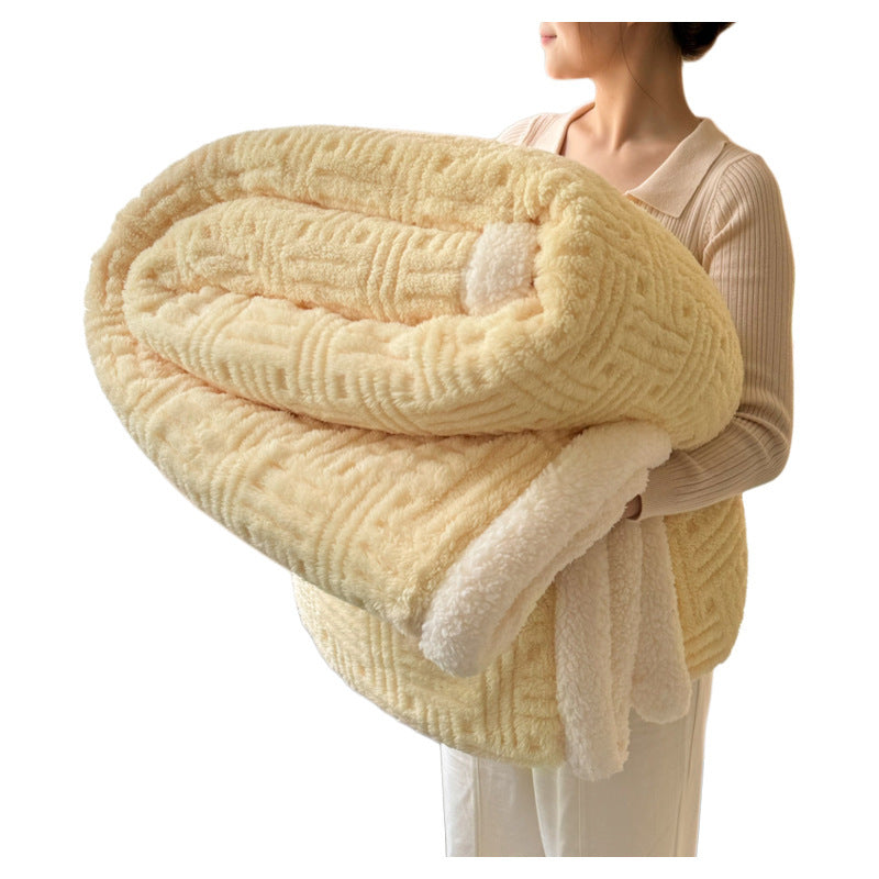 Plush velvet winter blanket in pale yellow with thick folded layers and striped trim