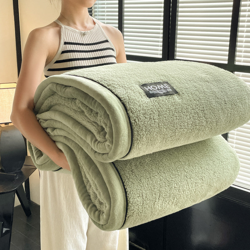 Velvet solid green blanket rolled, plush pile with black-edge trim and HOME label