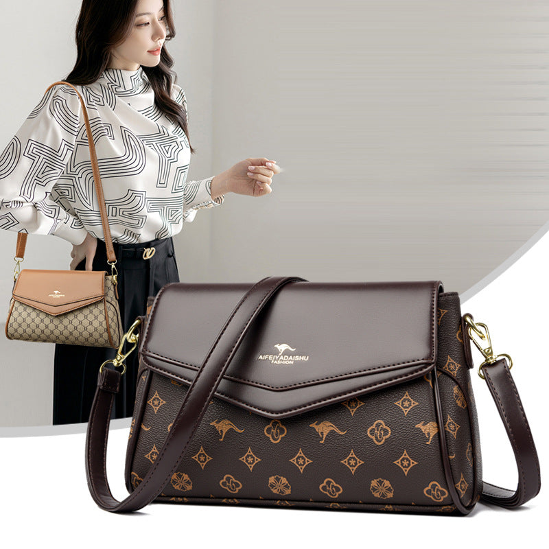Dark brown monogram crossbody shoulder bag with flap, gold-tone hardware, adjustable strap