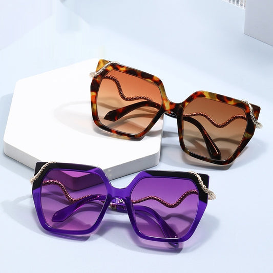 Two pairs of sunglasses with different colored lenses on a light blue background