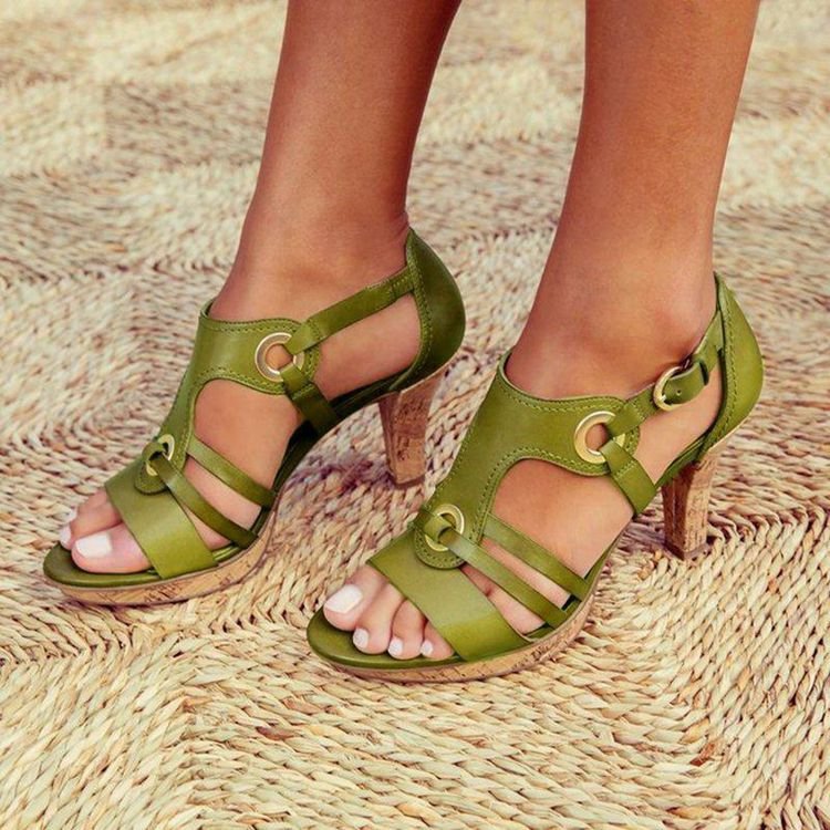 Green sandals worn on feet with a woven background
