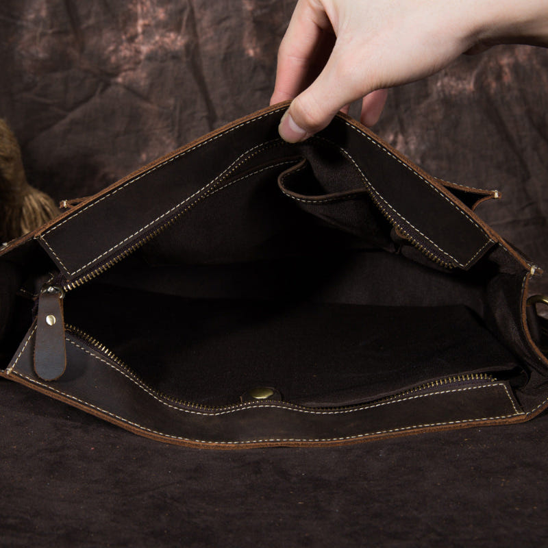 Leather handbag open top with zippered interior pocket and brown leather lining
