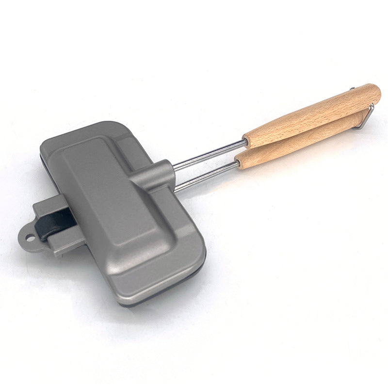 Foldable sandwich pan with wooden handle and hinged gray non-stick cooking surface
