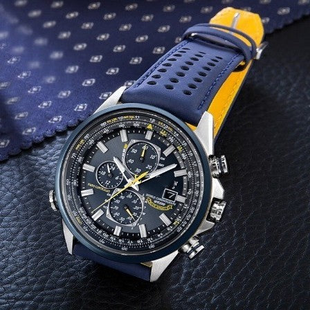 Wristwatch with blue strap and black dial on a textured surface