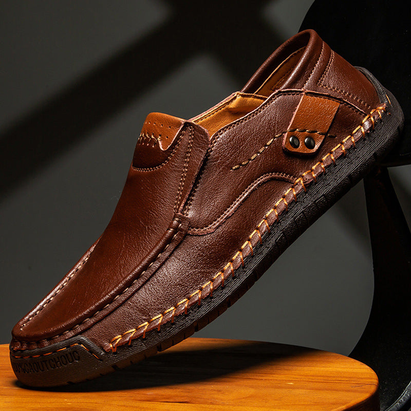 Dark brown leather slip-on loafer with stitched vamp and buckle strap detail