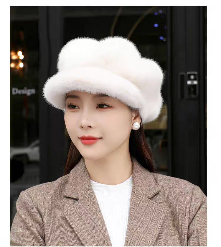 Woman wearing a white fur hat indoors with blurred background