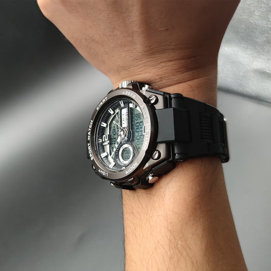 Men's dual-display quartz watch on wrist with black silicone band and round black dial
