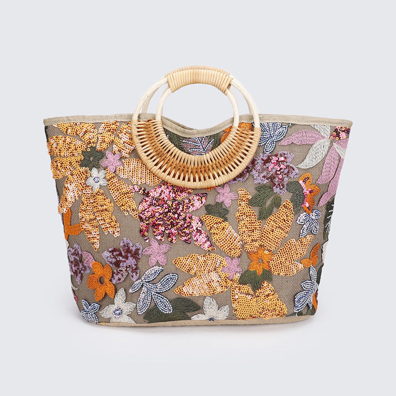 Large woven cotton tote bag with multicolor sequined floral pattern and rattan half-moon handle