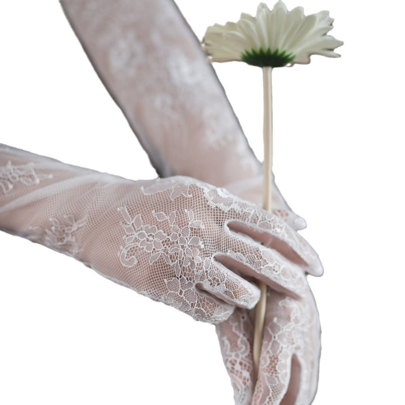White lace tulle bridal glove close-up with embroidered floral lace and finger openings