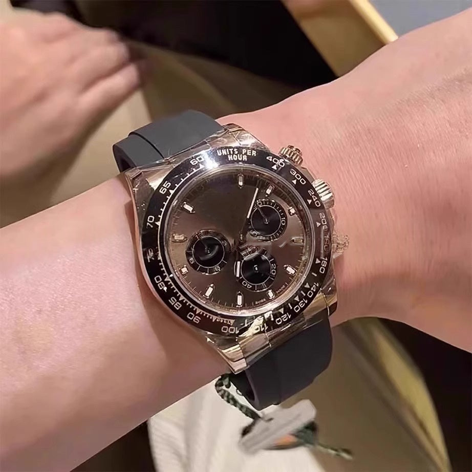 Mechanical wristwatch, black rubber strap; rose-gold case, dark dial with 3 subdials