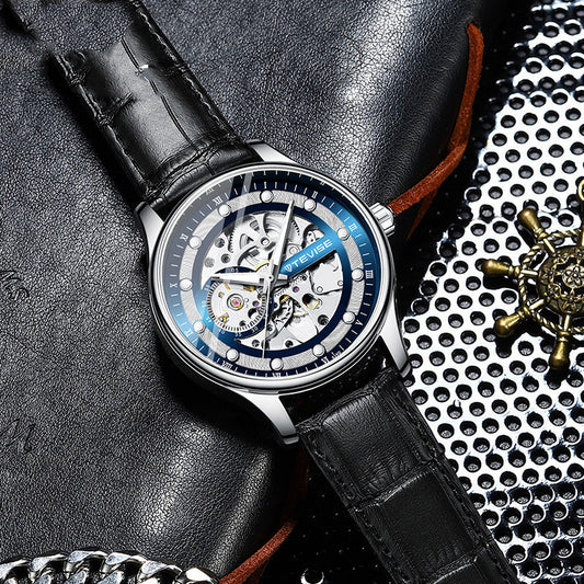 Mechanical watch with black leather strap and blue-accent skeleton dial, round steel case.