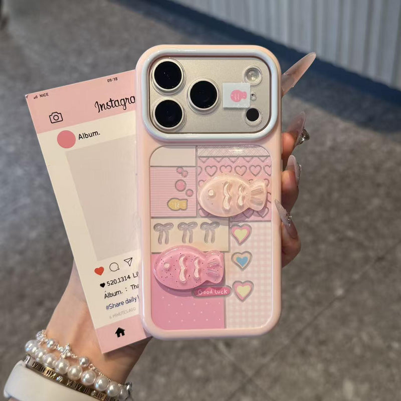 Pink iPhone case with heart pattern, plaid blocks, and raised 3D fish charm