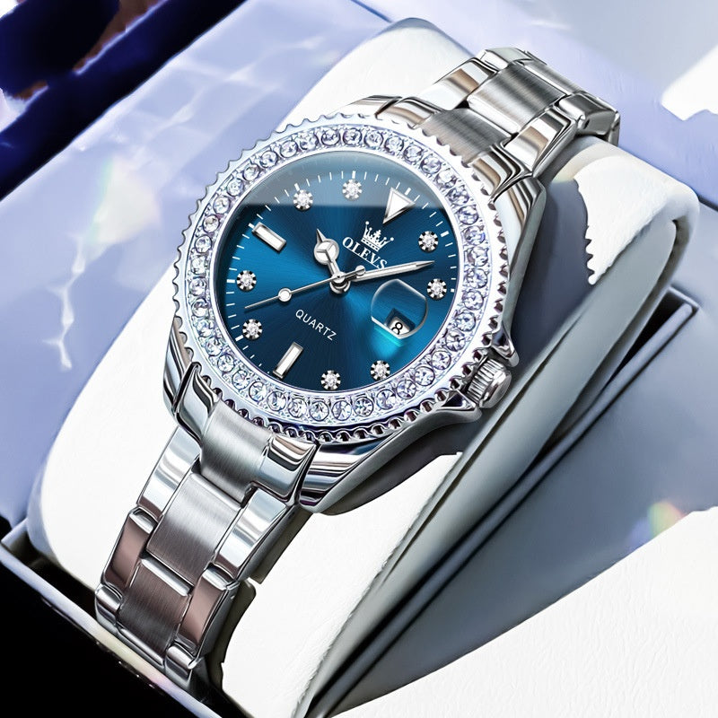 Quartz wristwatch with dark blue dial, crystal bezel, and silver metal link bracelet