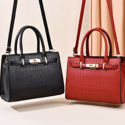 Black croc-textured tote bag with top handle and adjustable shoulder strap