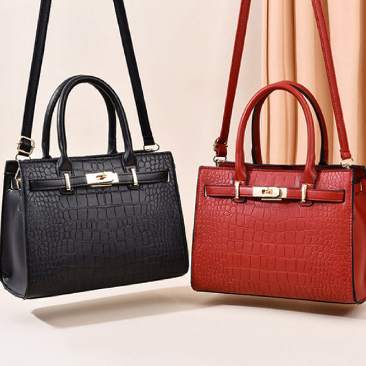 Black and red handbags with gold accents on a light beige background