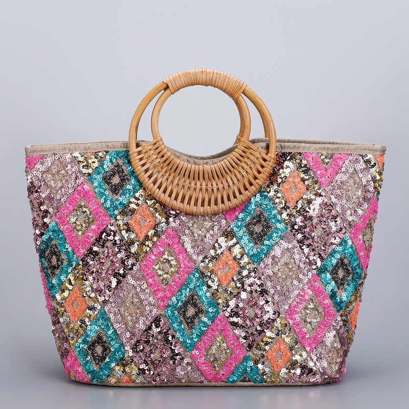 Large woven cotton tote bag with sequin diamond pattern and woven rattan top handles, pink and teal