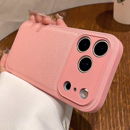 Pink phone case held by a person on a wooden surface